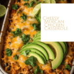 a casserole dish of cheesy mexican casserole with avocado and lime on top