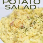white bowl of mustard potato salad with parsley on top