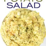 white bowl of mustard potato salad with parsley on top