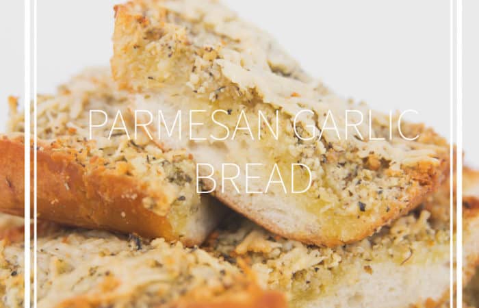white plate of cooked sliced paremsan garlic bread