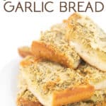 white plate of cooked sliced paremsan garlic bread with title