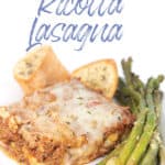 white plate of a piece of no ricotta lasagna with asparagus and toasted bread
