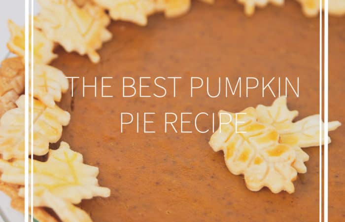 a pumpkin pie in a glass pan with leaf cut outs of crust