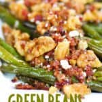 a close up shot of green beans topped with bacon, blue cheese, and walnuts