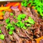 With these cilantro lime sheet pan fajitas you can make your entire dinner just on one pan. Juicy steak full of flavor you won't be disappointed. #fajitas #beef #beefdinner #dinner #sheetpandinner #onepandinner #mexicanfood #cilantro #cilantrolime #beefmarinade #easydinner #onions #peppers