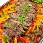 pan of sliced cilantro lime sheet pan fajitas with cilantro