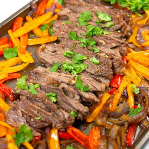 pan of sliced cilantro lime sheet pan fajitas with cilantro