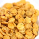 an up close shot of spicy ranch oyster crackers in a white bowl