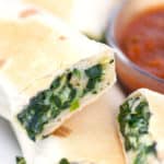 spinach and feta rolled in a tortilla and cooked with a cup of salsa
