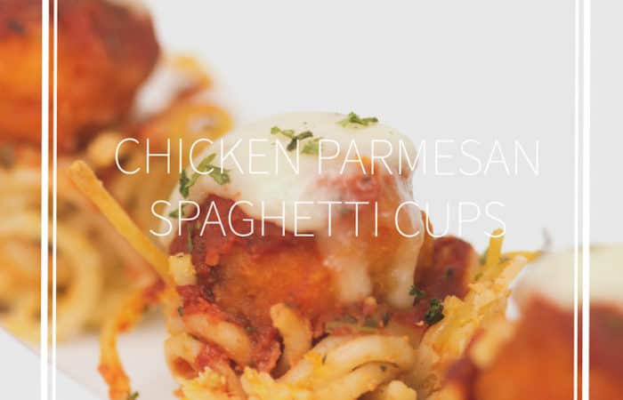 popcorn chicken with sauce and cheese on top of a bowl made of spaghetti on a white plate