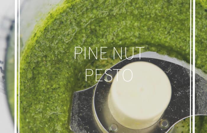 food processor bowl with green basil pine nut pesto