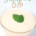 a glass bowl of spicy ranch jalapeno dip with basil leaves garnish