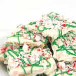 a white plate with white chocolate graham crackers with green drizzle and peppermints