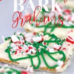 a baking pan with parchment paper with white chocolate graham crackers with green drizzle and peppermints