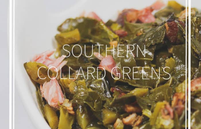 a white bowl of cooked collard greens with chunks of ham pieces