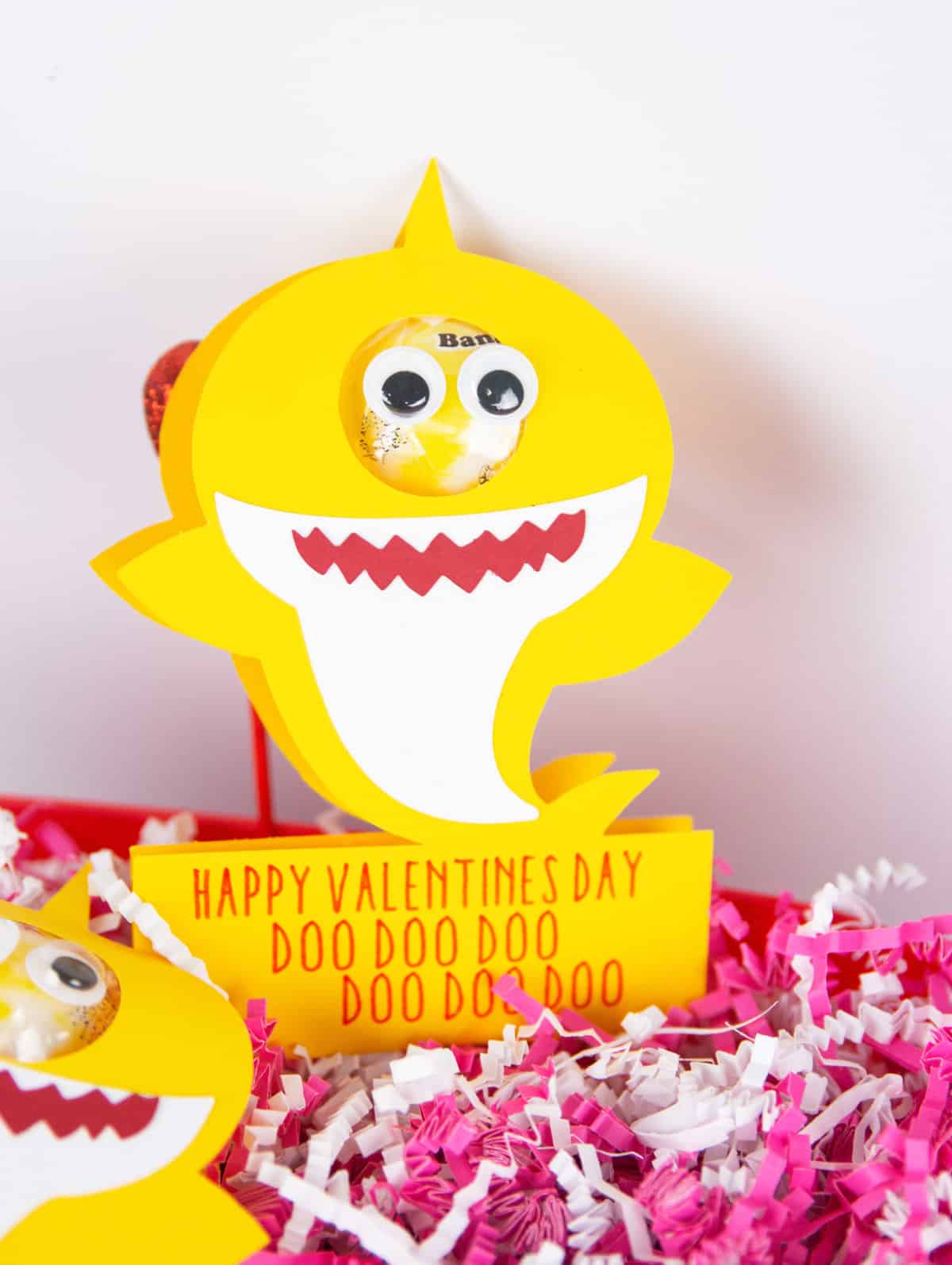 baby shark valentine made with cricut with a sucker with pink and white confetti