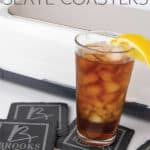 a cricut maker machine with personalized slate coasters with a glass of tea on one of them