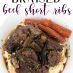 over head shot of white plate of red wine braised beef short ribs over mashed potatoes with mushrooms, carrots, and sauce