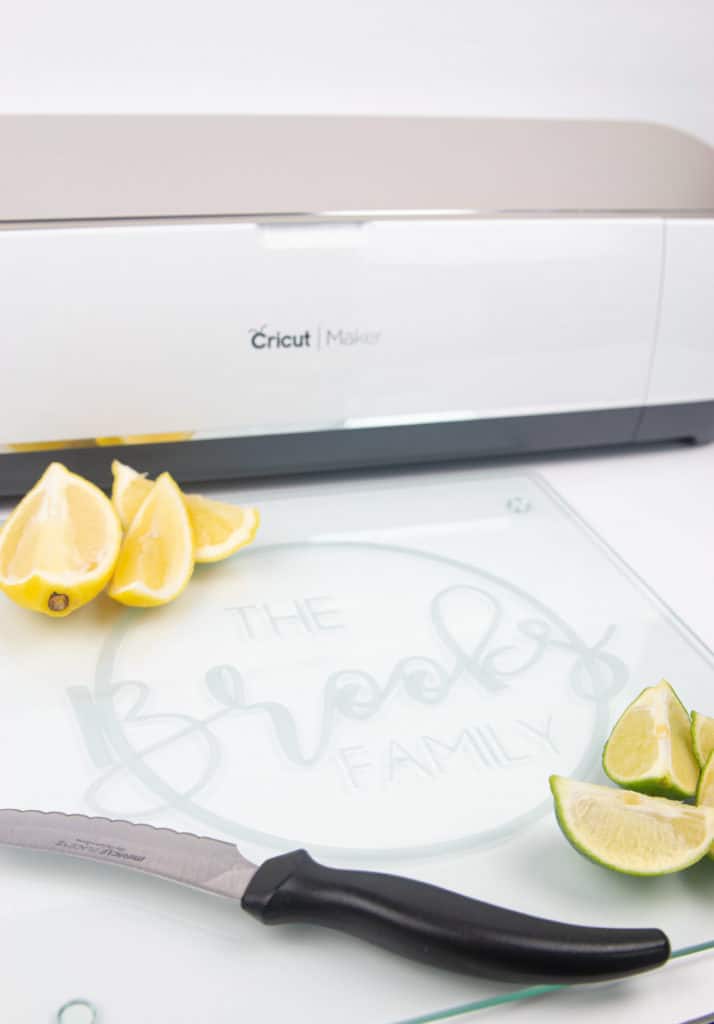 A cricut etched glass cutting board with limes, lemons and a knife
