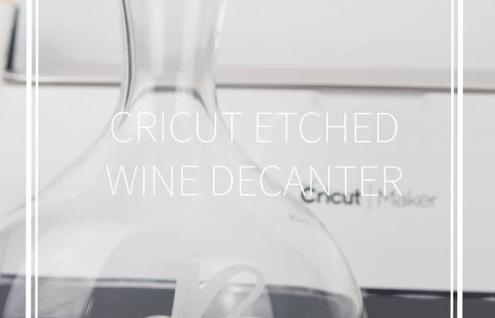 etched glass wine decanter with a cricut maker behind it