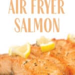 a glass plate of easy air fryer salmon pieces on top of brown rice with lemon on top of the salmon