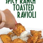 plate of air fried toasted spicy ranch ravioli with one dipping in ranch dressing