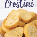 a white bowl of toasted baguette bread for easy crostini