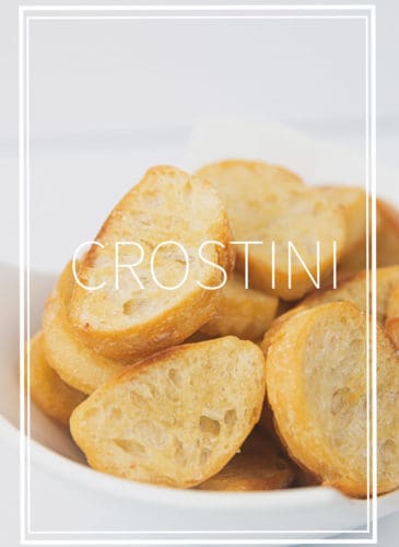 a white bowl of toasted baguette bread for easy crostini