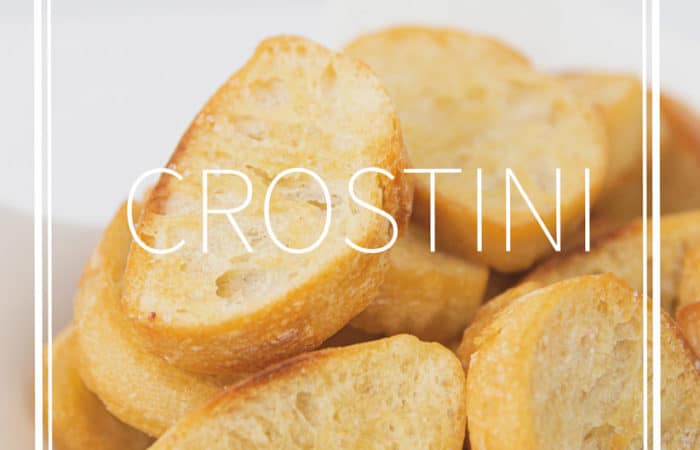 a white bowl of toasted baguette bread for easy crostini