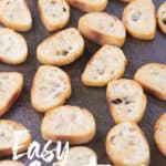 a sheet pan of slice baguette bread toasted for easy crostini