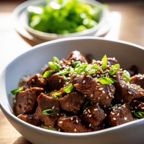 a bowl of the Best Slow Cooker Korean Beef with green onions on top