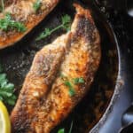 tilapia cooking in a pan