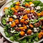 a big bowl of Pumpkin & Feta Salad with Pecans & Cranberries