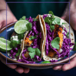 plate of spicy tilapia tacos with red cabbage, cilantro