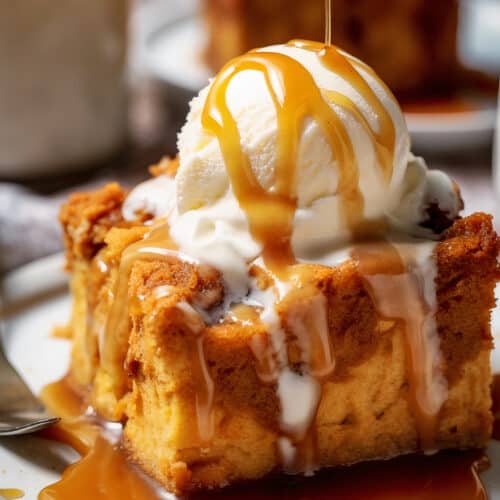 a piece of pumpkin bread pudding with vanilla ice cream on top with caramel drizzle on top